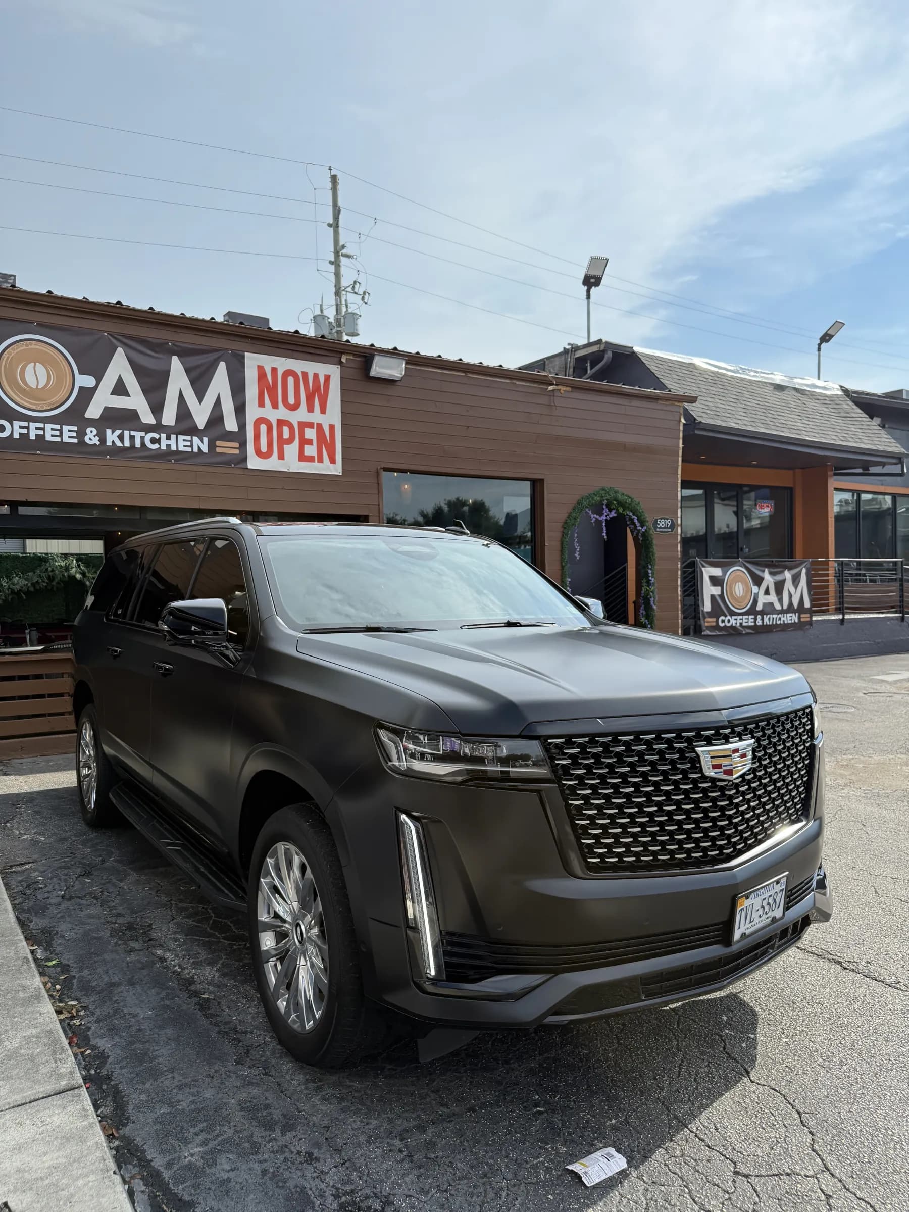 Cadillac Escalade wrapped in satin black outside the Houston shop