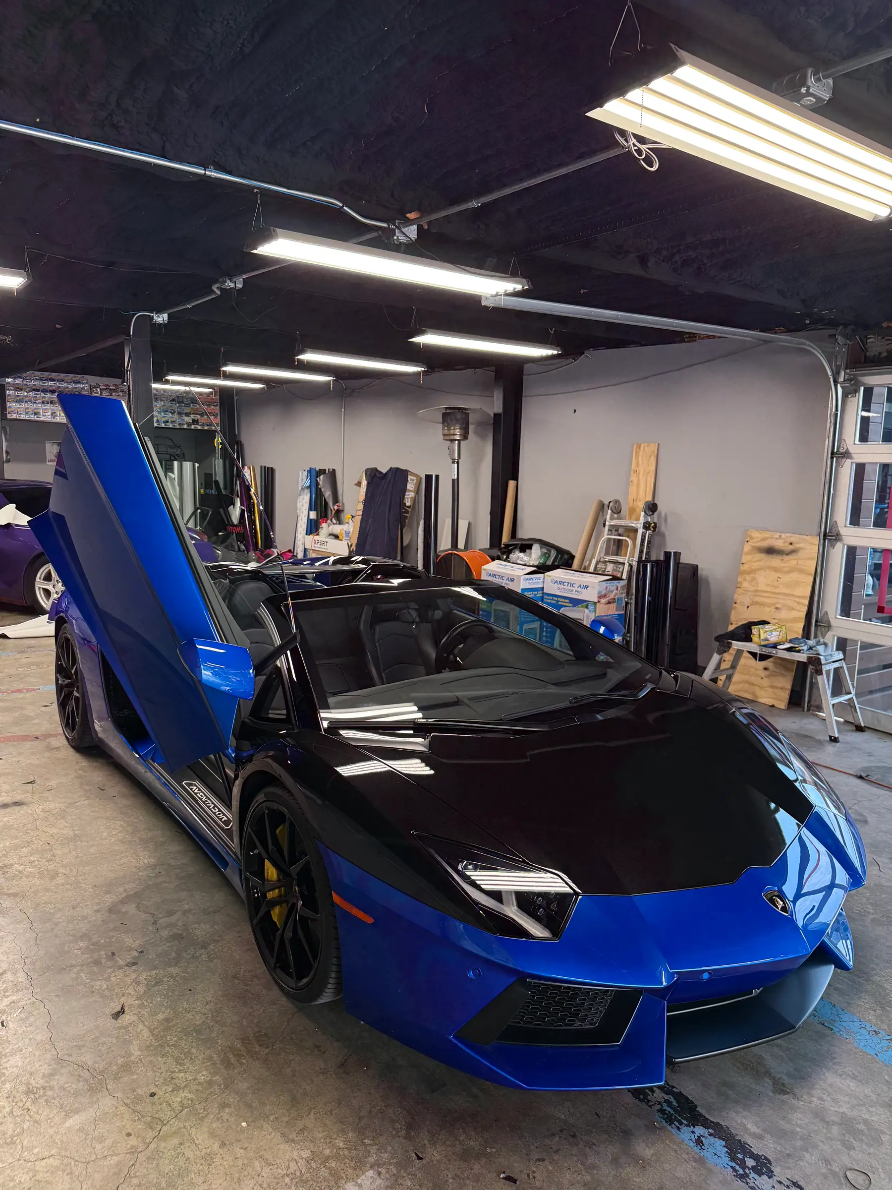 Lamborghini Aventador with scissor doors open during a build